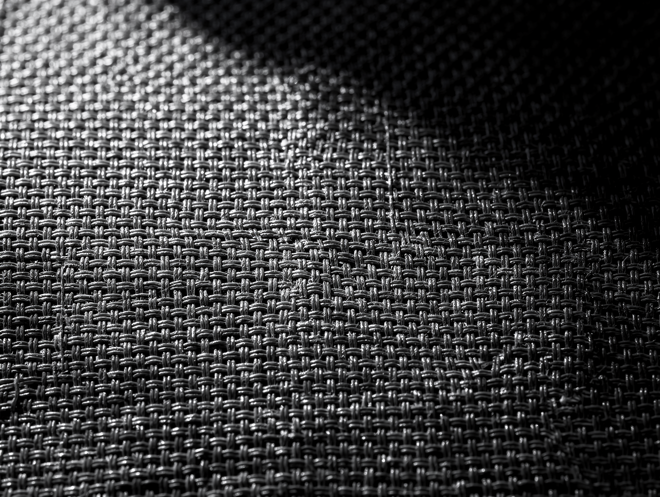 Microscopic dark weave pattern of Omni Amino Clothing Shadow-Knit textile